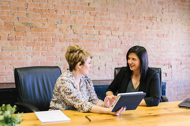 women discussing employee benefits